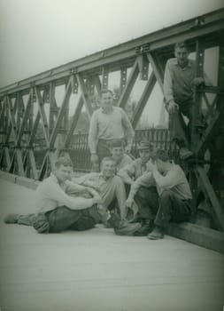 THE CZECHOSLOVAK SOCIALIST REPUBLIC - CIRCA 1970s: Retro photo shows combat engineers - sappers pose on the bridge construction. Vintage photography. Circa 1970.