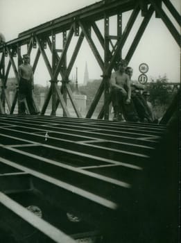 THE CZECHOSLOVAK SOCIALIST REPUBLIC - CIRCA 1970s: Retro photo shows combat engineers - sappers pose on the bridge construction. Vintage photography. Circa 1970.