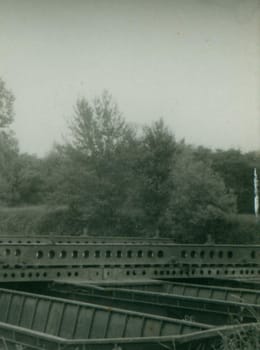 THE CZECHOSLOVAK SOCIALIST REPUBLIC - CIRCA 1970s: Retro photo shows pieces of the bridge construction - pontoon bridge. Vintage photography. Circa 1970.