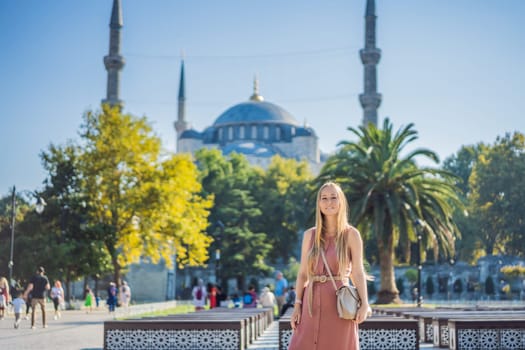 Woman tourist enjoying the view Blue Mosque Sultanahmet Camii Istanbul, Turkey.