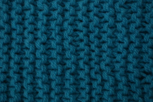 Abstract background of blue knitted woolen threads close-up...