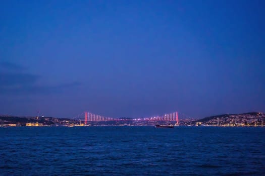 Istanbul at sunset, Turkey. Tourist boat sails on Golden Horn in summer. Beautiful sunny view of Istanbul waterfront with old mosque. Concept of travel, tourism and vacation in Istanbul and Turkey. Turkiye.