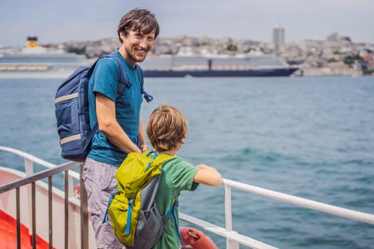 Happy Dad and son Tourists enjoying the sea from ferry boat crossing Bosphorus in Istanbul. Summer trip to Istanbul. Traveling with kids concept.