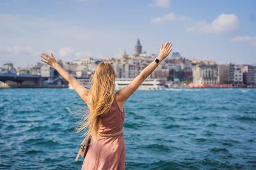 Portrait of beautiful woman tourist with view of Galata tower in Beyoglu, Istanbul, Turkey. Turkiye.