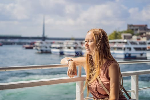 Happy woman enjoying the sea from ferry boat crossing Bosphorus in Istanbul. Summer trip to Istanbul.