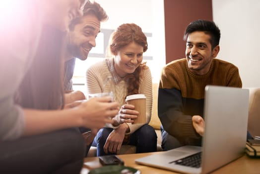 Coffee with friends is all the therapy you need. young people using a laptop in a coffee shop