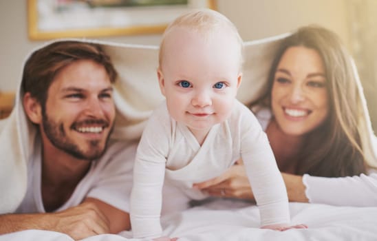 My parents and me. a young couple and their baby daughter in the bedroom