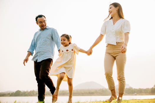 A happy family walking and playing together in a beautiful nature setting, feeling the joy and the beauty of the season of spring, Happy family day