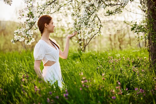 Pretty woman in blossom spring garden. High quality photo