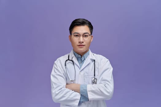 Portrait of male confident doctor over  purple, healthcare and Medical technology concept.