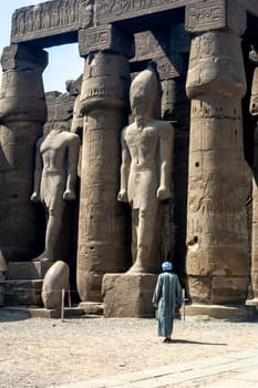 Luxor, Egypt - April 15 2008: The great statues of Ramses II with local population, Karnak, Luxor, Egypt