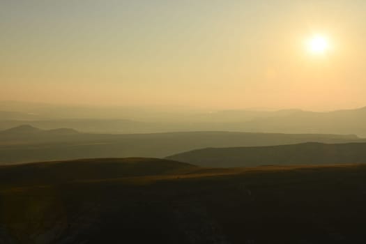 Idyllic landscape of hills in fog at sunrise in Cappadocia, Turkey