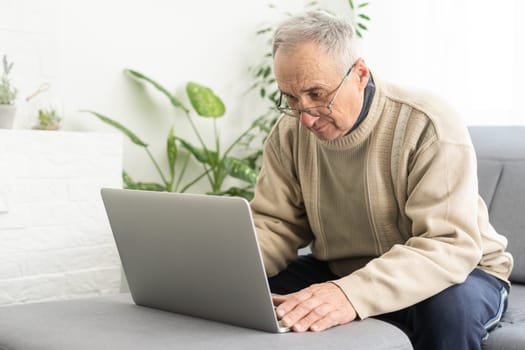 Busy smart mature professional man using laptop sitting. Middle aged older adult businessman, senior entrepreneur of mid age remote working or learning online typing on computer