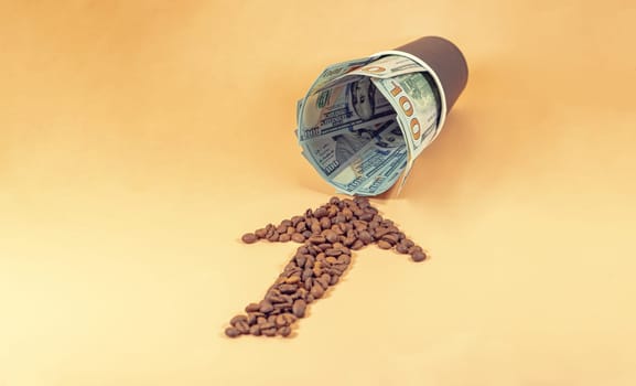 An arrow made of coffee beans points to a disposable paper cup