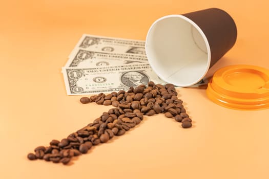 An arrow made of coffee beans points to a disposable paper cup