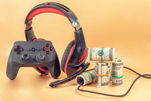 Game kit in red and black: wireless gamepad and audio headset. Such things help a gamer to earn money