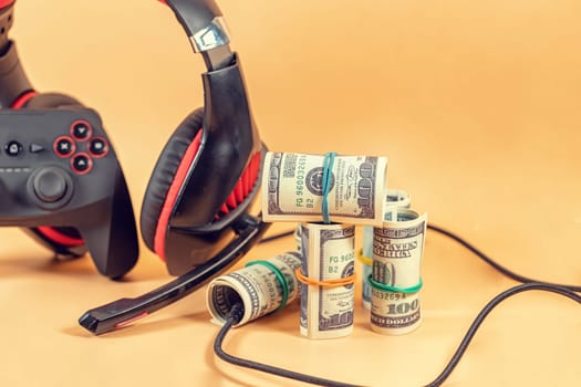 Game kit in red and black: wireless gamepad and audio headset. Such things help a gamer to earn money