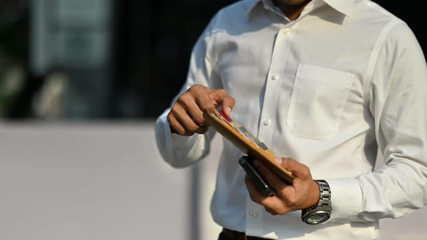 Shot of man taking a credit card from his wallet, technology digital of business finance and cashless transactions concept.