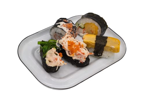 Assorted Sushi rolls (Japanese sushi food) on an iron plate isolated on white background with clipping path. Delicious japanese food with sushi rolls. Selective focus.