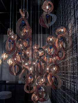 Bangkok,Thai - Apr 29, 2022 : Softly shining hanged lamps with Braided Colorful Ropes, which means in Chinese Lucky Number Eight with dark background. Beautiful decor for the interior, 8 infinity unlimited lucky signs concept, No focus, specifically.