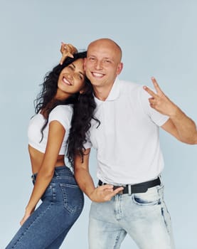 Gesturing and having fun. Cheerful couple is together indoors.