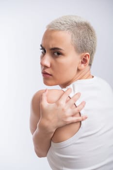 Pretty young woman with a short blond haircut on a white background