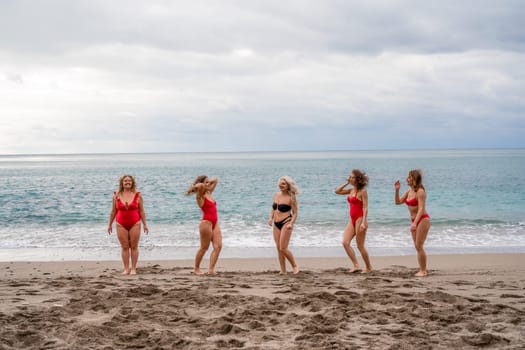 Big happy family or group of five friends is having fun against sunset beach. Beach holidays concept