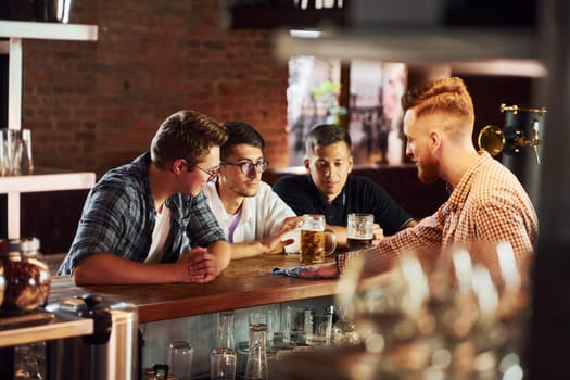 People in casual clothes sitting in the pub.