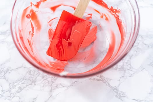 Dirty kitchen tools in a glass mixing bowl after baking a cake.