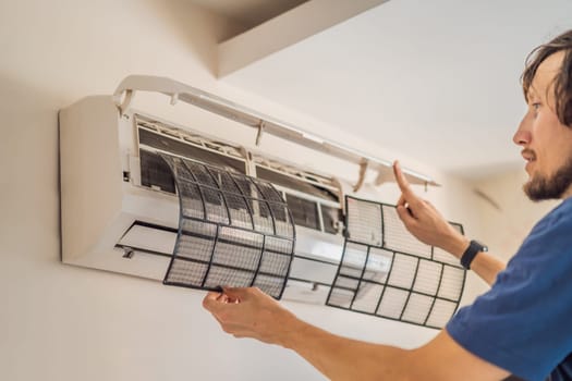 technician service removing air filter of the air conditioner for cleaning.