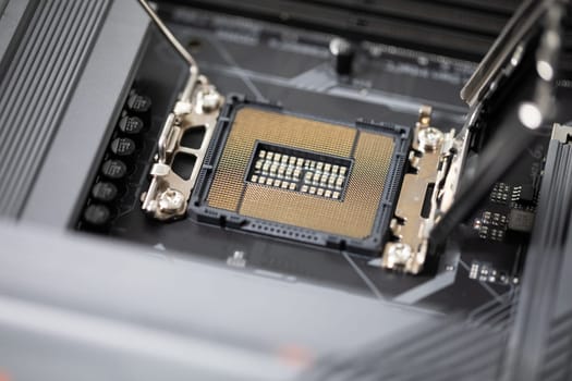 Close-up of the computer motherboard. Laptop repair by a professional. Replacement of computer parts to improve the quality of use.
