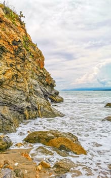 Extremely beautiful huge big surfer waves rocks cliffs stones and boulders on the beach in Zicatela Puerto Escondido Oaxaca Mexico.