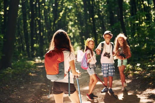 Ready for adventure. Kids strolling in the forest with travel equipment.