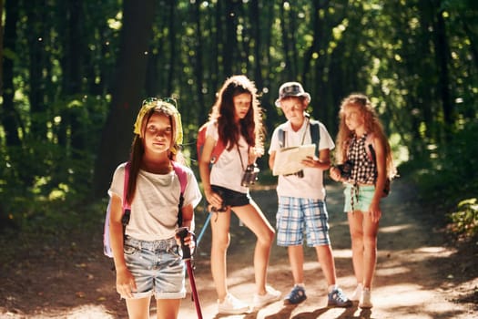 Ready for adventure. Kids strolling in the forest with travel equipment.
