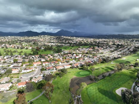 Aerial view of residential neighborhood surrounded by golf and valley during cloudy day in Rancho Bernardo, San Diego County, California. USA.