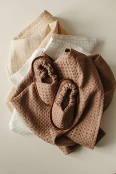 Set of linen - bathrobe, slippers and towel. Close-up.
