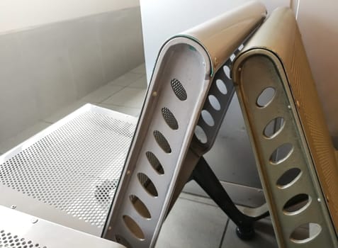 Uncomfortable metal bench / chair at airport waiting hall.