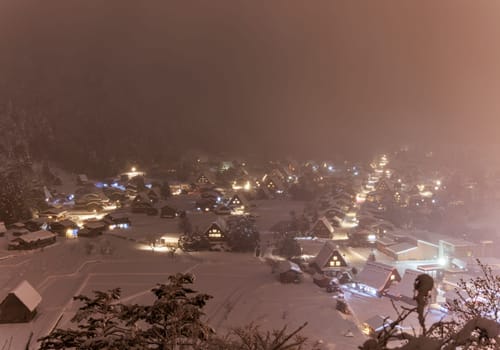 Shirakawa-go Houses Bathed in Pink Snowy Mist on Winter Night. High quality photo