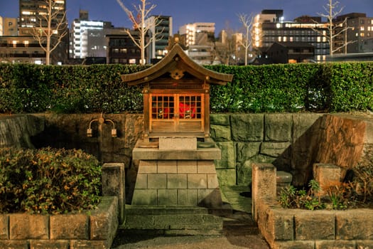 Small shrine in Japanese city at night. High quality photo