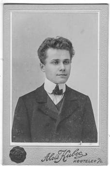 KOSTELEC NAD ORLICI, CZECHOSLOVAKIA - CIRCA 1920: Vintage cabinet card shows portrait of young man. Photo was taken in a photo studio.