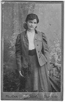 POLICKA, CZECHOSLOVAKIA - CIRCA 1920: Vintage cabinet card shows portrait of the young woman. Photo was taken in a photo studio.