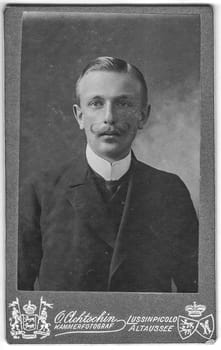 WIEN, AUSTRIA - HUNGARY - JULY 19, 1908: Vintage cabinet card shows portrait of the middle-aged man with moustache. Edwardian fashion. Photo was taken in a photo studio. Photo was taken in Austro-Hungarian Empire or also Austro-Hungarian Monarchy