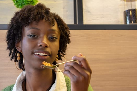 A Moment of Sweet Joy: Close-Up Shot of a Young Afro-American Woman Enjoying a Tempting Slice of Cake. High quality photo