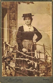 W RGL, AUSTRIA-HUNGARY - CIRCA 1900: Vintage cabinet card shows woman posing in a photo(graphic) studio. Photo was taken in Austro-Hungarian Empire or also Austro-Hungarian Monarchy