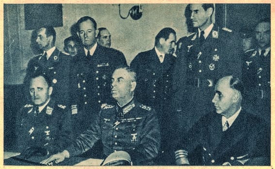 BERLIN, GERMANY - MAY 8, 1945: At a ceremony in the Soviet military headquarters in Berlin, Luftwaffe commanding General Hans Stumpf, Field Marshal Wilhelm Keitel, and Admiral Hans-Georg von Friedeburg prepare to sign the unconditional surrender.