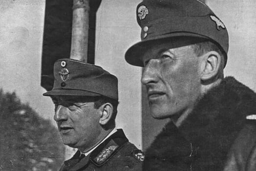 KITZBUHEL, AUSTRIA - 1941: In the photo Kurt Daluege and Reinhard Heydrich. Daluege following Reinhard Heydrich's assassination in 1942, he served as Deputy Protector for the Protectorate of Bohemia and Moravia. Daluege directed the German measures of retribution for the assassination, including the Lidice massacre. After the end of World War II, he was extradited to Czechoslovakia, tried, convicted and executed in 1946.