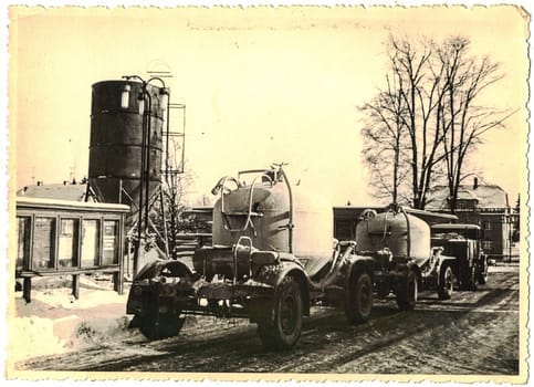 FRAUREUTH, EAST GERMANY - FEBRUARY 1965: Retro photo shows lorry pulls cistern trailer. Circa 1960s.