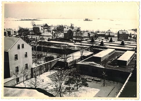 FRAUREUTH, EAST GERMANY - FEBRUARY 1965: The retro photo shows old industry zone in former East Germany. Black and white photo.