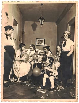 GERMANY - CIRCA 1950s: The retro photo shows a group of happy girls celebrate a social event - New Year Eve, birthday, ladies party...Golden the fifties or the sixties.