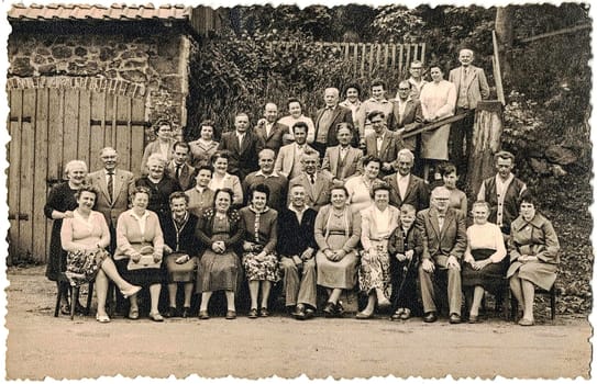 TANNE-OBERHARZ AM BROCKEN, GERMANY - APRIL 27, 1968: Retro photo shows a group of people - relatives. Village photo from late the sixties